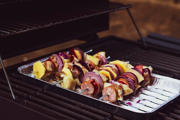 Sausage skewers with slices of sweet peppers potato and onion tasty food top view weekend meal