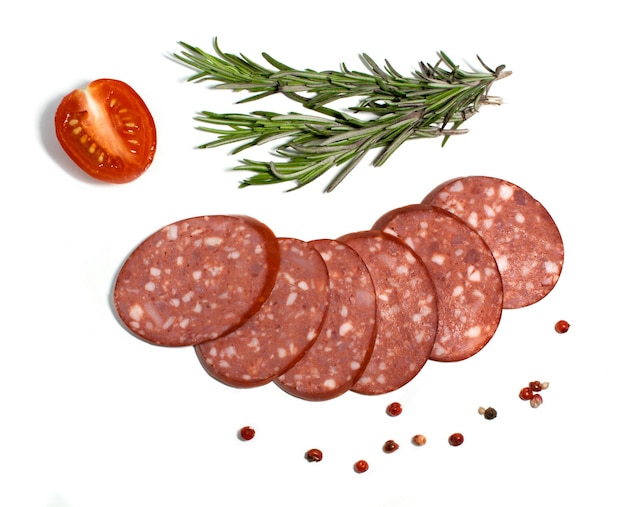 Sausage slices with rosemary and cherry tomato semi or half\
smoked sausage isolated on white