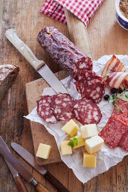 Sausage with cheese on chopping board