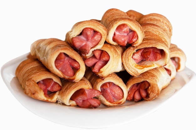 Sausage wrapped in dough on a plate fast food closeup Homemade sausages in dough Selective focus