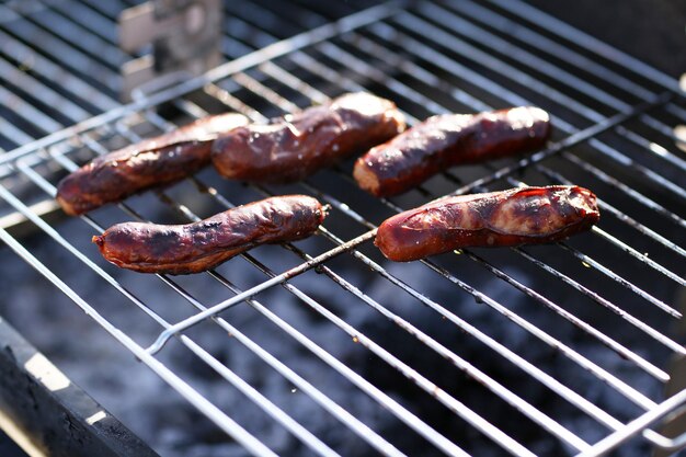 Sausages on barbecue grill closeup