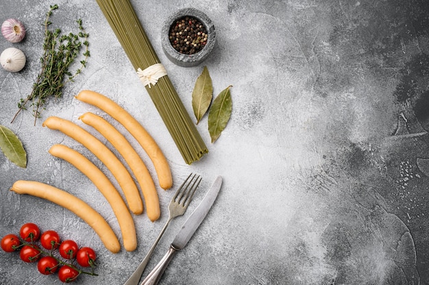 Sausages chicken meat products set, on gray stone table background, top view flat lay, with copy space for text