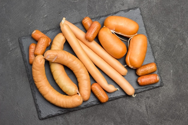 Sausages of different varieties on slate board