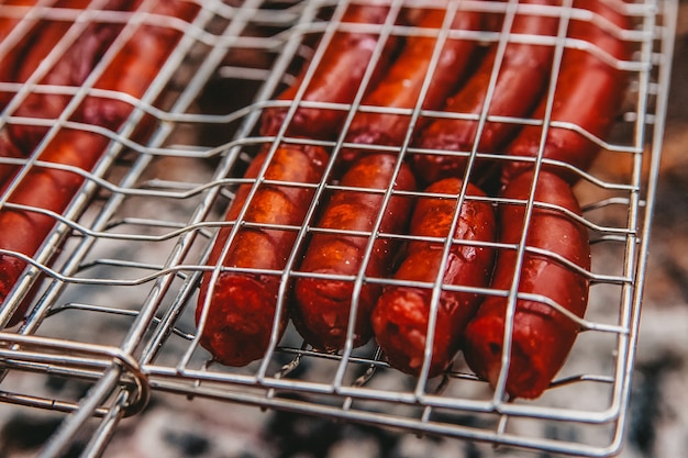 Sausages on fire on a portable barbecue