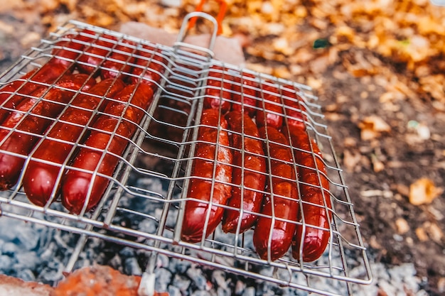 Sausages on fire on a portable barbecue