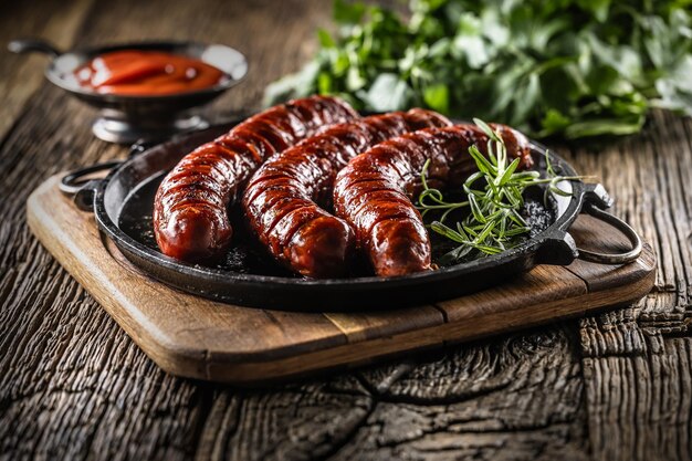 Sausages fried with spices bbq sauce and herbs Close up