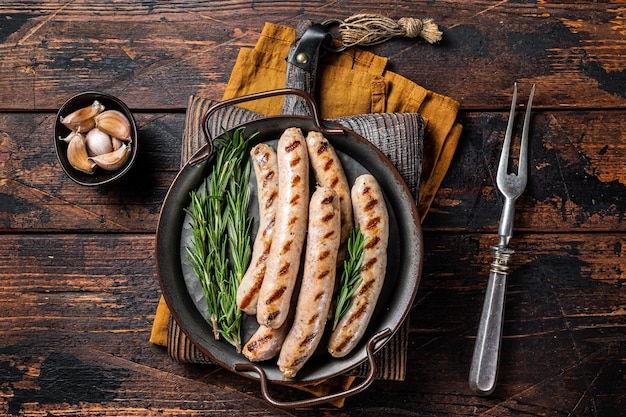 Sausages fried with spices and herbs meat Bratwurst Wooden background Top view