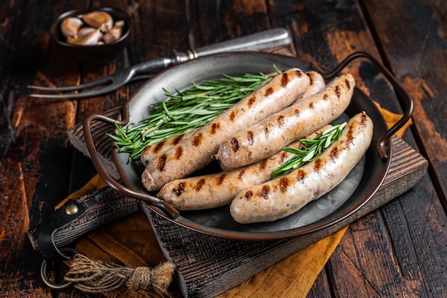 Sausages fried with spices and herbs meat Bratwurst Wooden background Top view