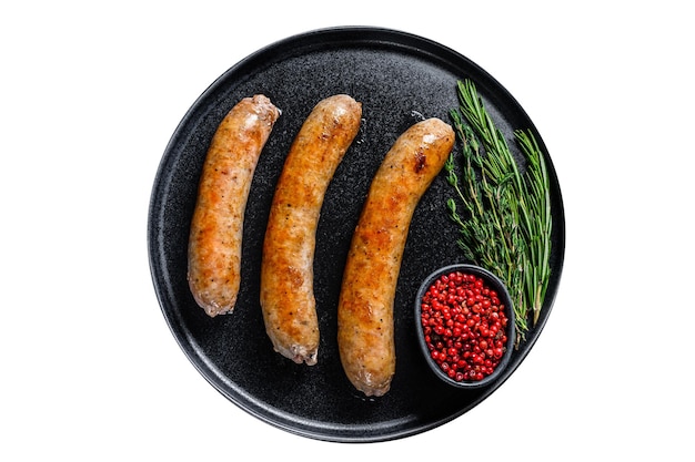 Sausages fried with spices and herbs on a plate Isolated on white background