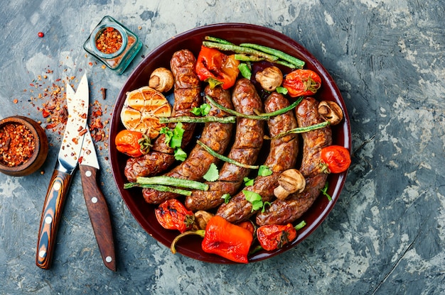 Sausages fried with vegetable