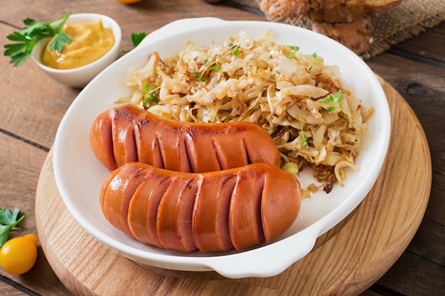 Sausages on the grill pan on the wooden table