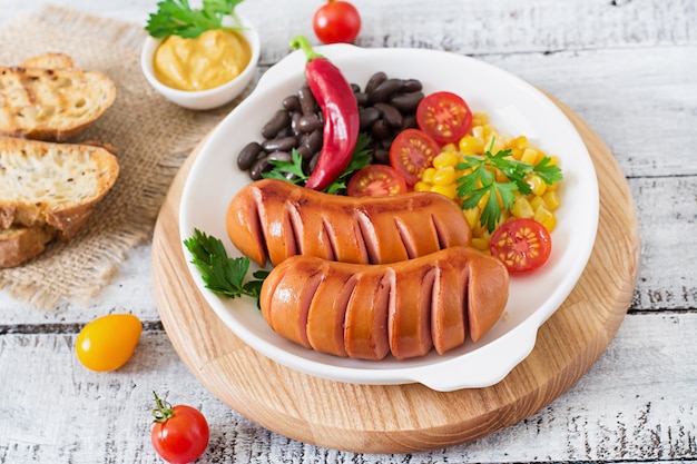 Sausages on the grill pan on the wooden table