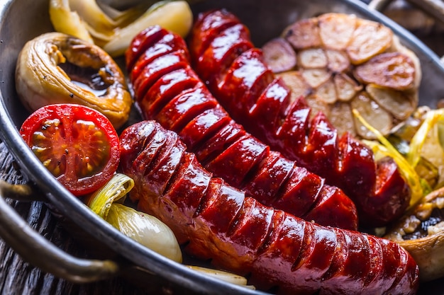 Sausages. Grill sausages. Grilled sausage with mushrooms garlic tomatoes and onions.