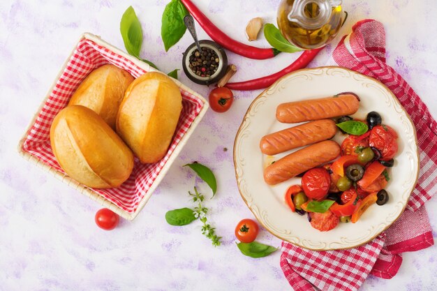 Sausages grilled with vegetables in the Greek style on plate