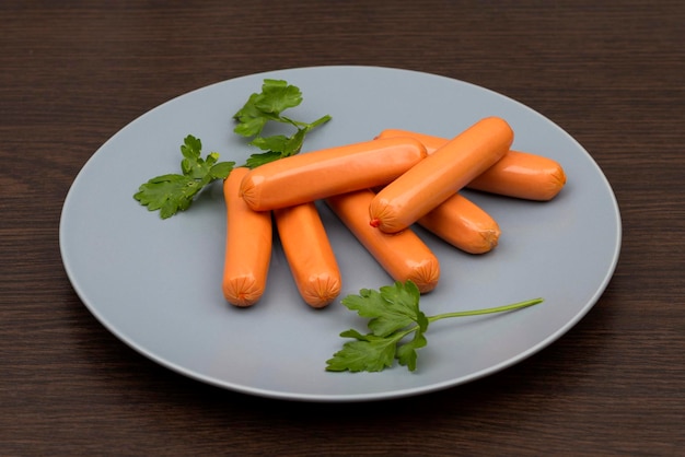 sausages and parsley on a gray plate Delicious breakfast with greens