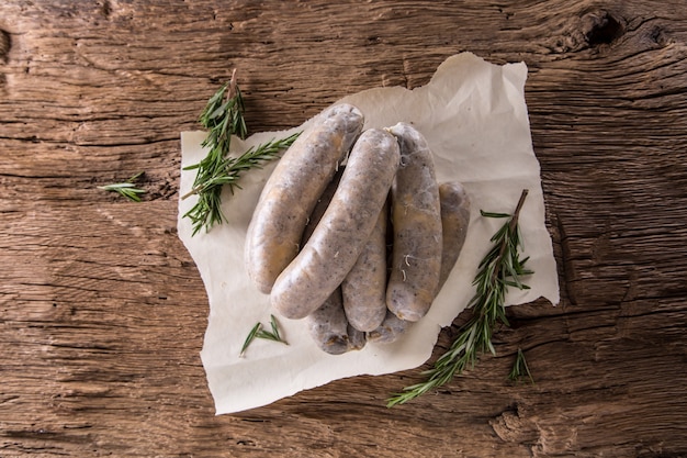 Sausages. Raw pork sausages on oak wooden table.