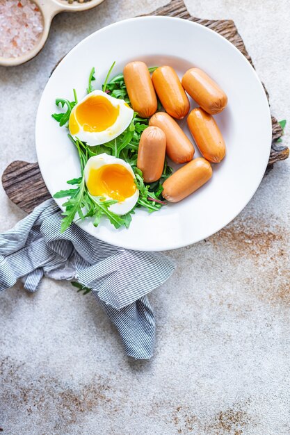 Sausages salad poached egg leaves green petals lettuce mix fresh healthy