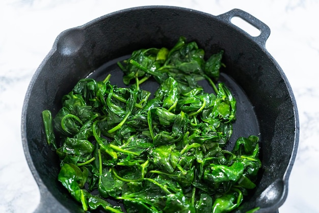 Sauteeing spinach for spinach and ham frittata