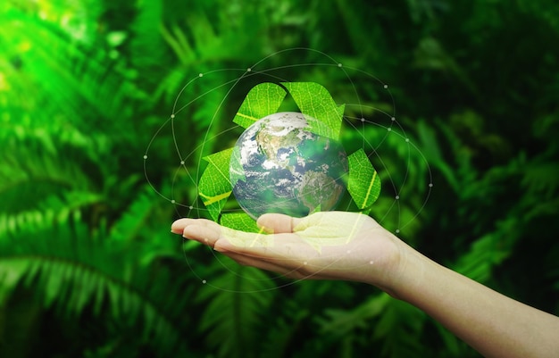 Save earth concept Hands with Earth and recycle logo over green nature background Earth image