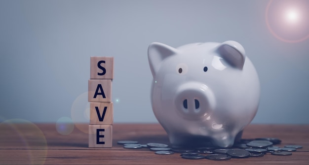 Save from wood cubes and piggy bank Money savings save and investmentbusiness concept