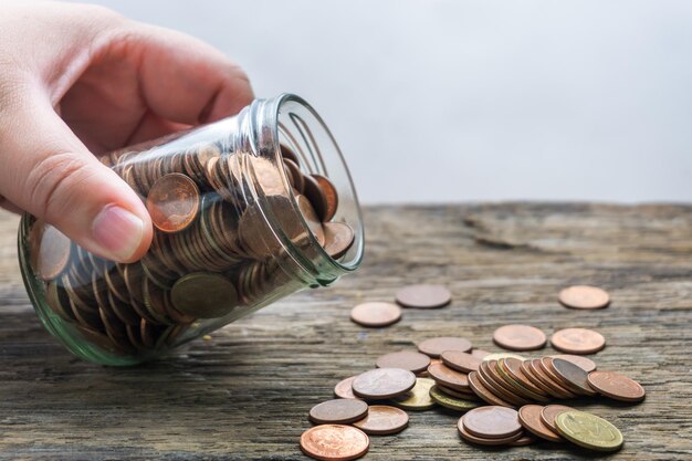 save money and account banking for finance concept, hand with coin on blurred background