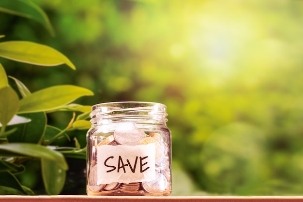 Save money, coins in glass jar for money saving financial concept