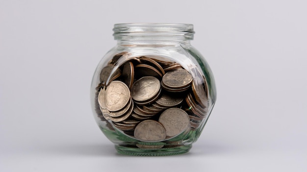 Saving coins in a glass jar savings concept financial planning and investment Cash flow and income