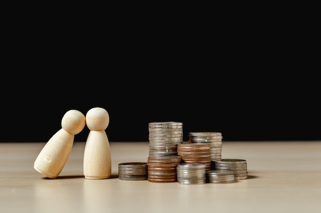 Photo saving for future concept wooden doll people human couple relationship with coins stack investment business