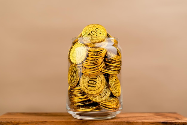 Saving gold saving money gold savings concept in a glass jar\
store gold in a glass jar