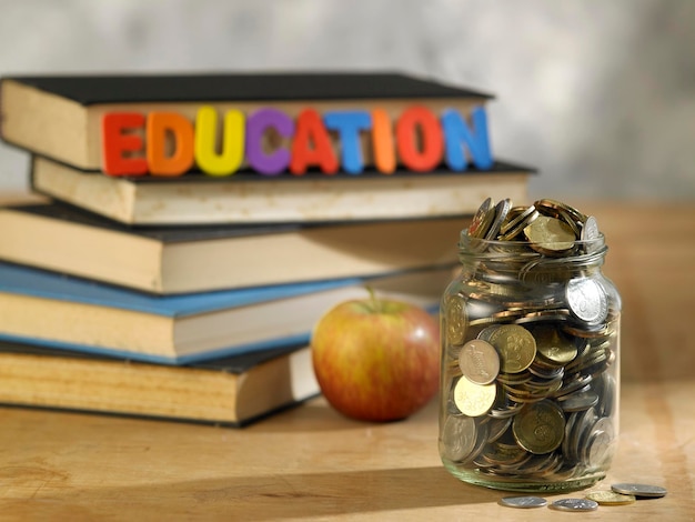 Photo saving jar with coins on top of books