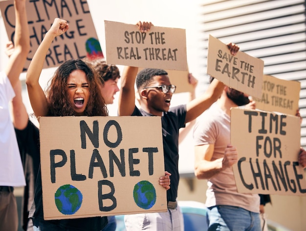 Saving what we have while we have it shot of a group of people holding up signs at a protest rally