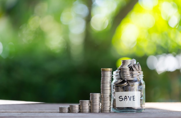 Savings deposit coins in a clear glass bottle