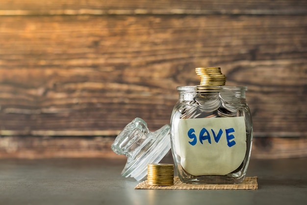 Savings deposit coins in a clear glass bottle