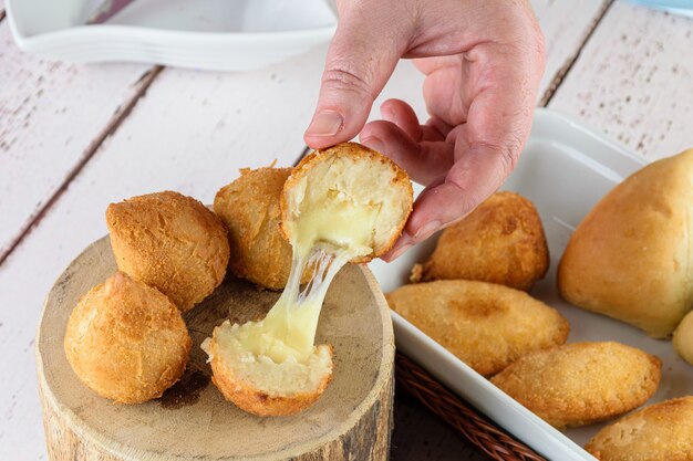 Savory Brazilians stuffed with melted mozzarella cheese. Served on a wooden log.