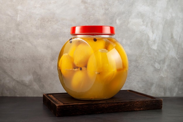 Savory country lemon fruits in glass jar. Salted Moroccan lemons. Fermented food. Moroccan cuisine.