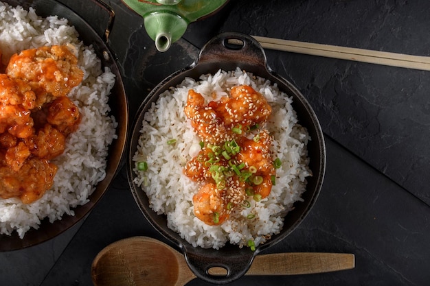 Savory delights closeup of deepfried orange chicken served on a bed of steamed white rice in 4k