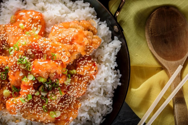 Savory Delights CloseUp of DeepFried Orange Chicken Served on a Bed of Steamed White Rice in 4k