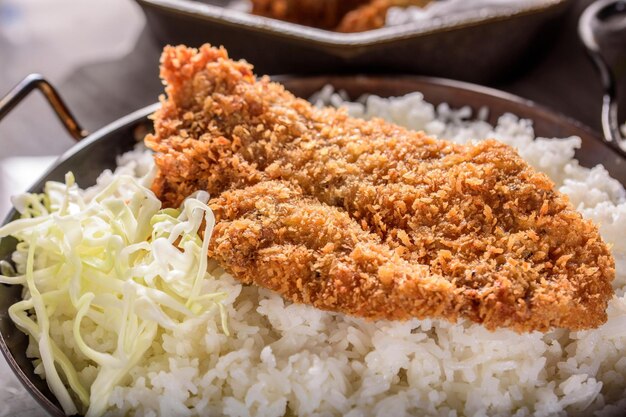 Savory Delights CloseUp of DeepFried Orange Chicken Served on a Bed of Steamed White Rice in 4k