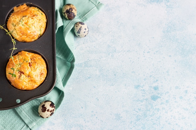 Savory muffins with bacon, quail egg, green onion and cheese