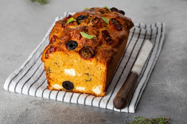 Photo savoury cake with tomatoes olives and feta cheese