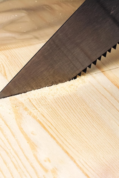 Sawing a wood board with a saw