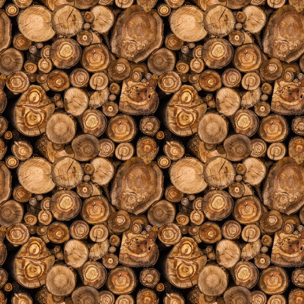 Photo sawn tree trunks stacked in a woodpile. seamless pattern