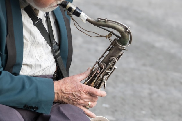 Saxophone in the hands of a street musician