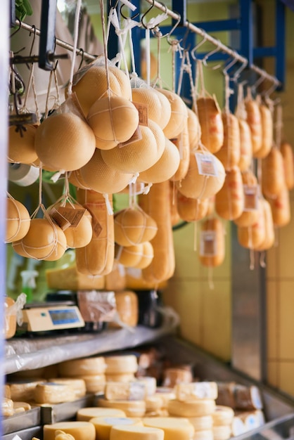 Say cheese Shot of a wide variety of different types of cheeses grouped together at a market stall outside during the day