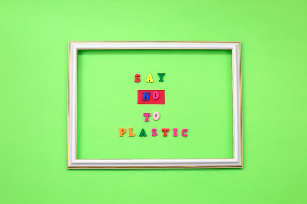 Say NO to plastic on wooden letters on green 