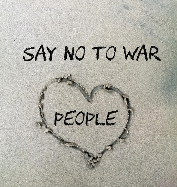Say no to war and love people text on sand art