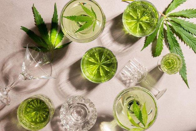 Sbd hemp drink in various glasses light concrete background\
hard shadow energy cocktail cannabis