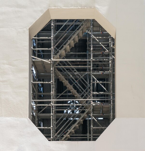 Photo scaffolding seen through window at construction site