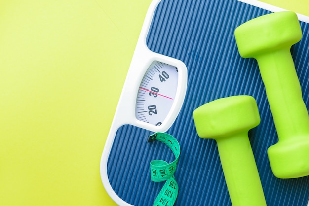 Photo scales, dumbbells and measuring tape. weight loss concept