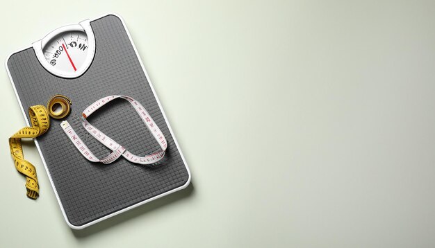 Photo scales and measuring tape on light background flat lay space for text